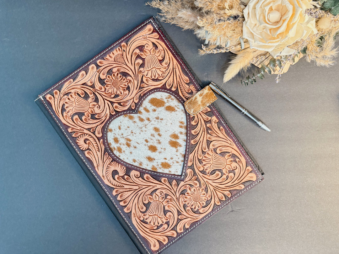 Handcrafted tooled leather portfolio with a cowhide heart inlay. Fits a standard legal pad or planner. Stylish, durable, and Western-inspired — curated by East Coast Carry.
