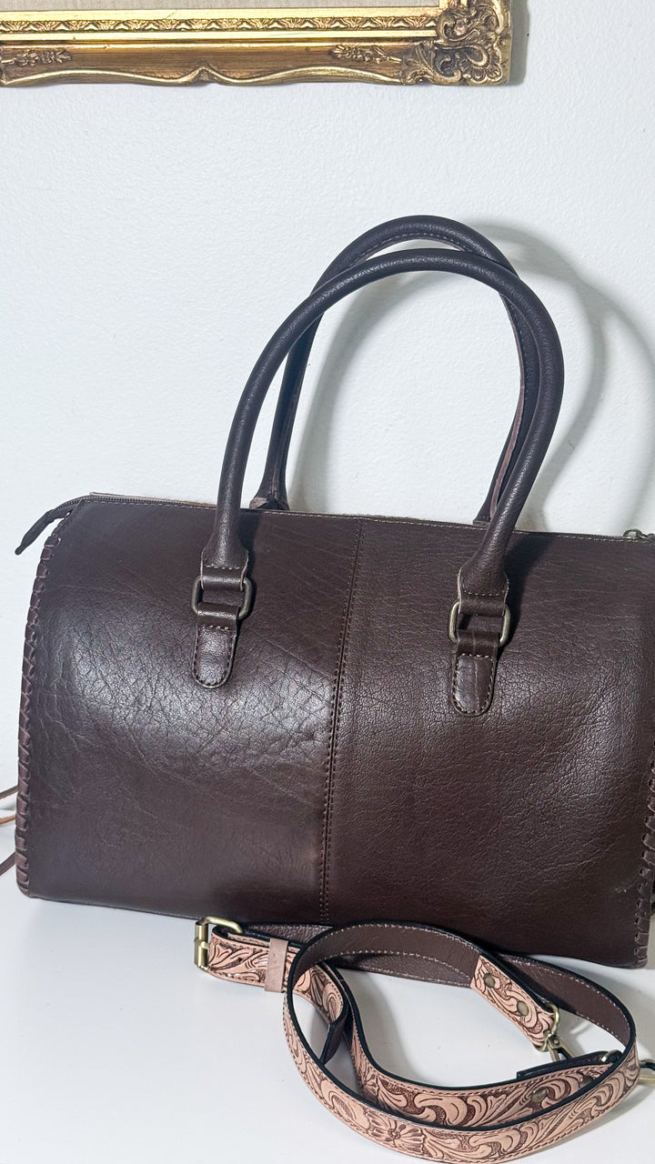 Back of The Olde Money Western satchel showing rich brown leather, hinged rolled double handles and structured handbag silhouette.