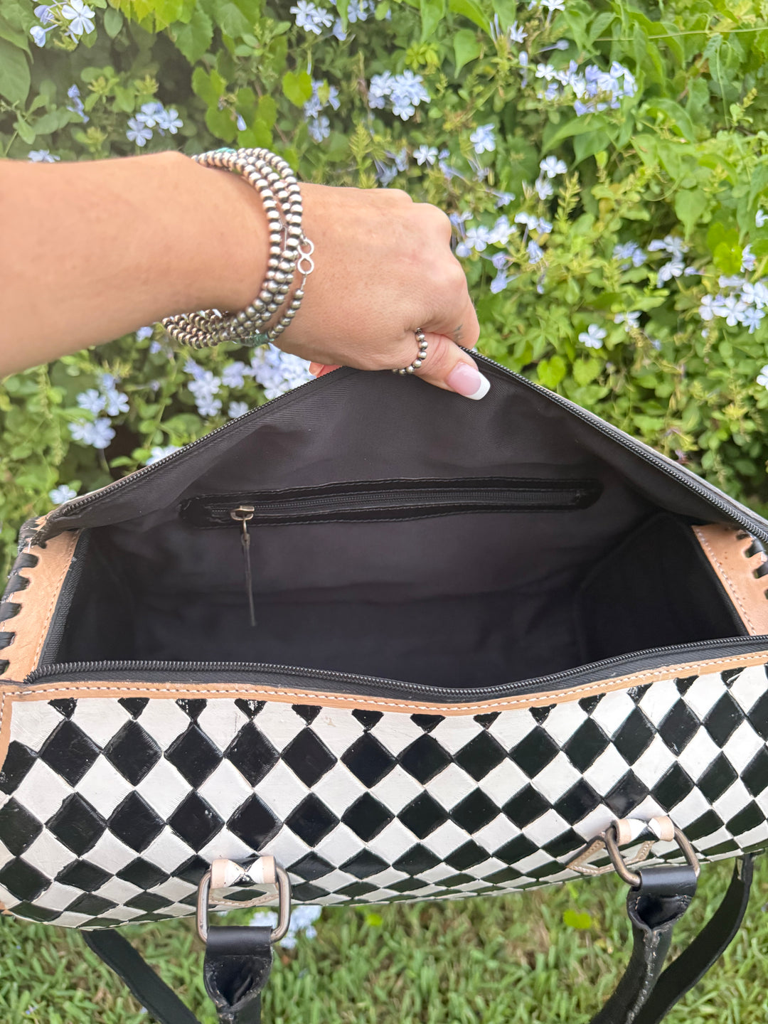 Open view of the Speed Check bag showing spacious interior and zippered pocket.