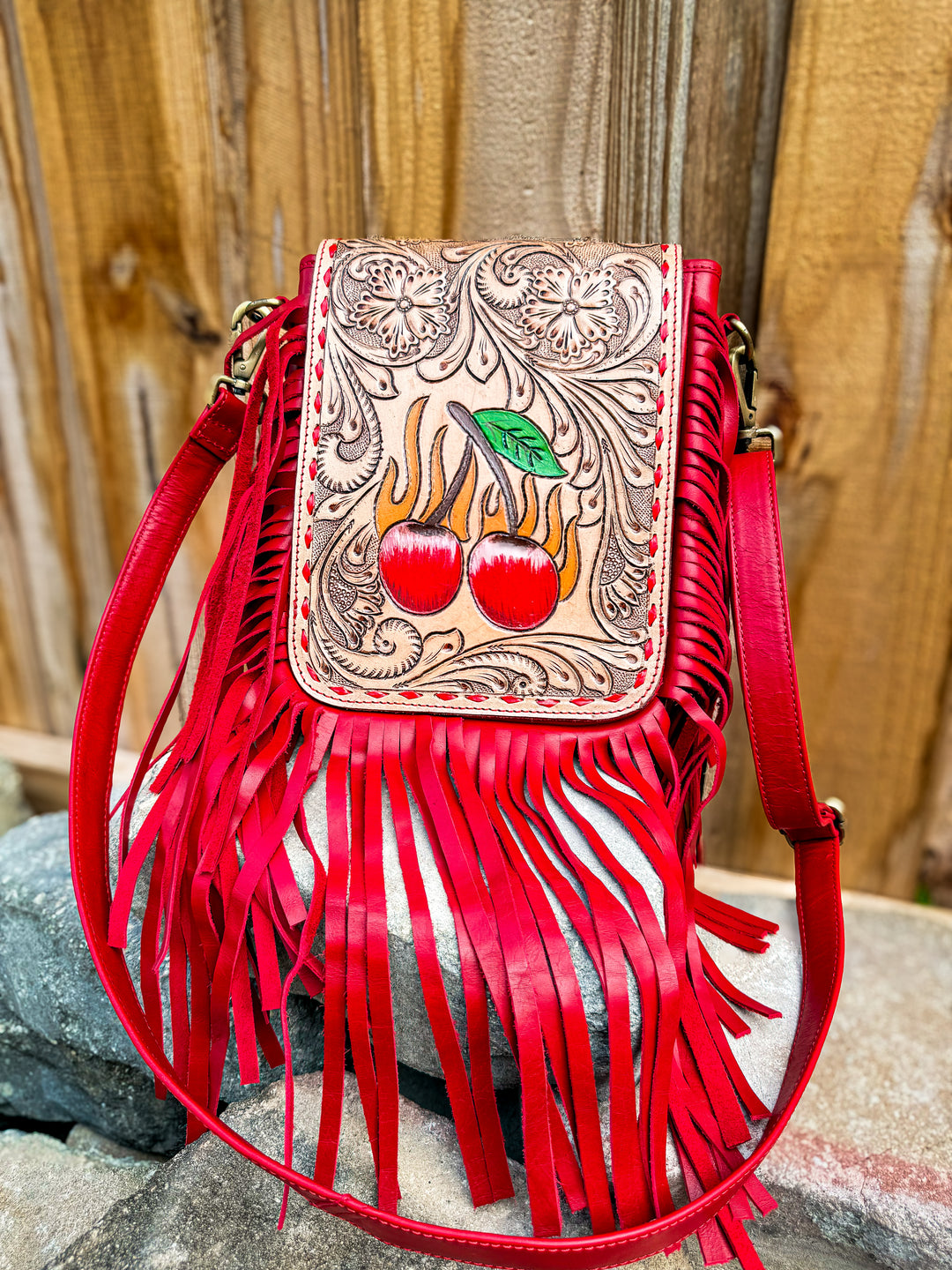 Red fringe crossbody bag with hand-tooled leather flap and hand-painted cherries