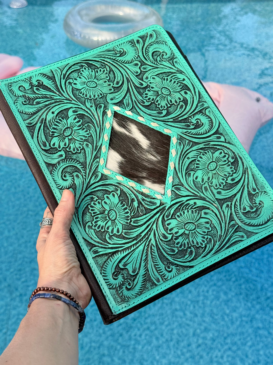 Turquoise tooled leather office Padfolio organizer with a black and white cowhide diamond shaped center piece 