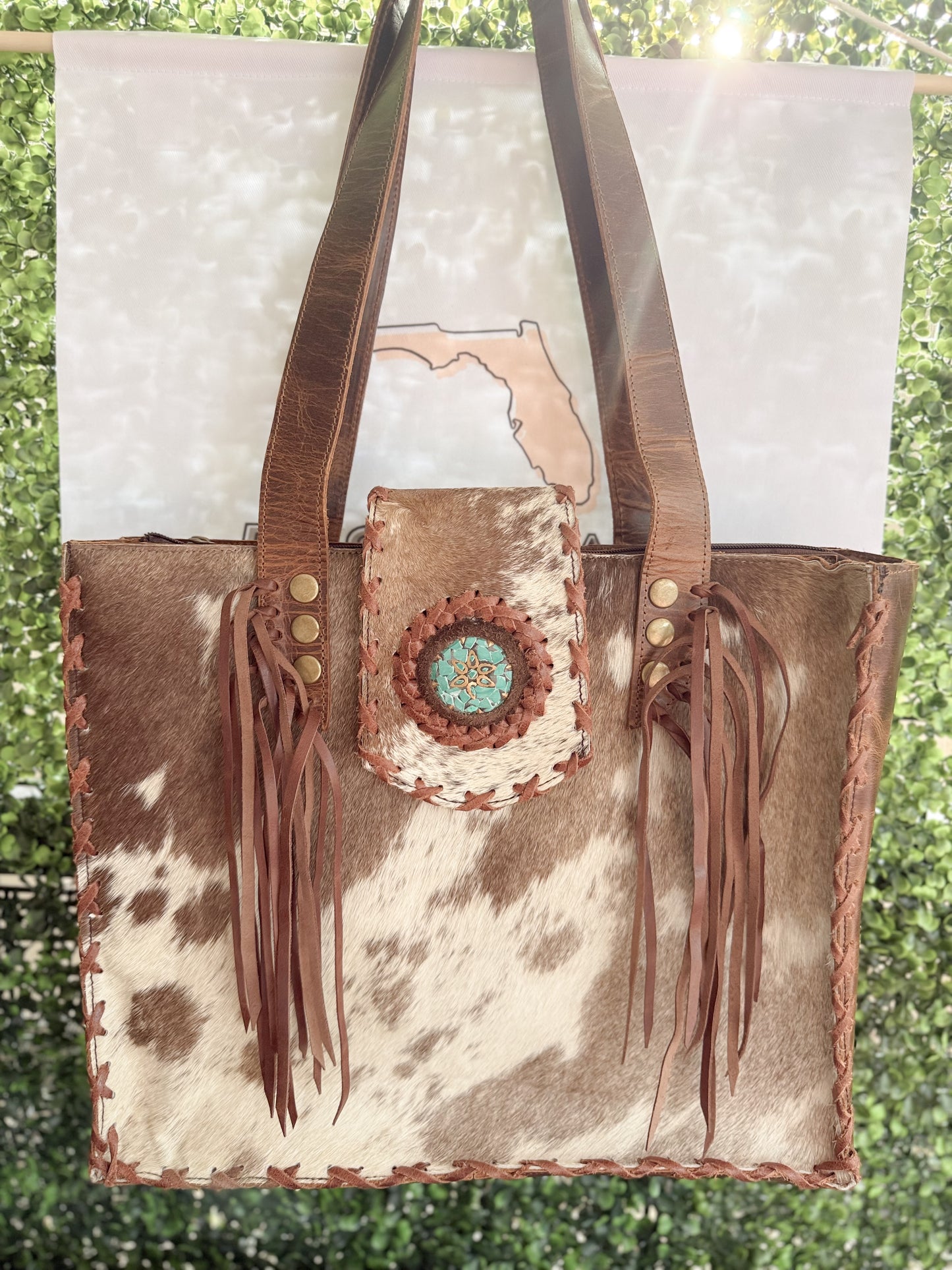 Palomino Bluff tote in hair-on cowhide and brown crunch leather with turquoise concho