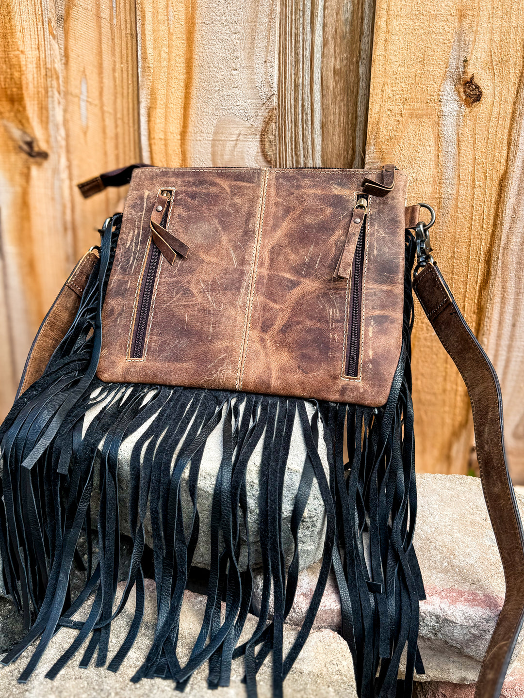 Back view of concealed carry purse with dual zipper compartments and black fringe
