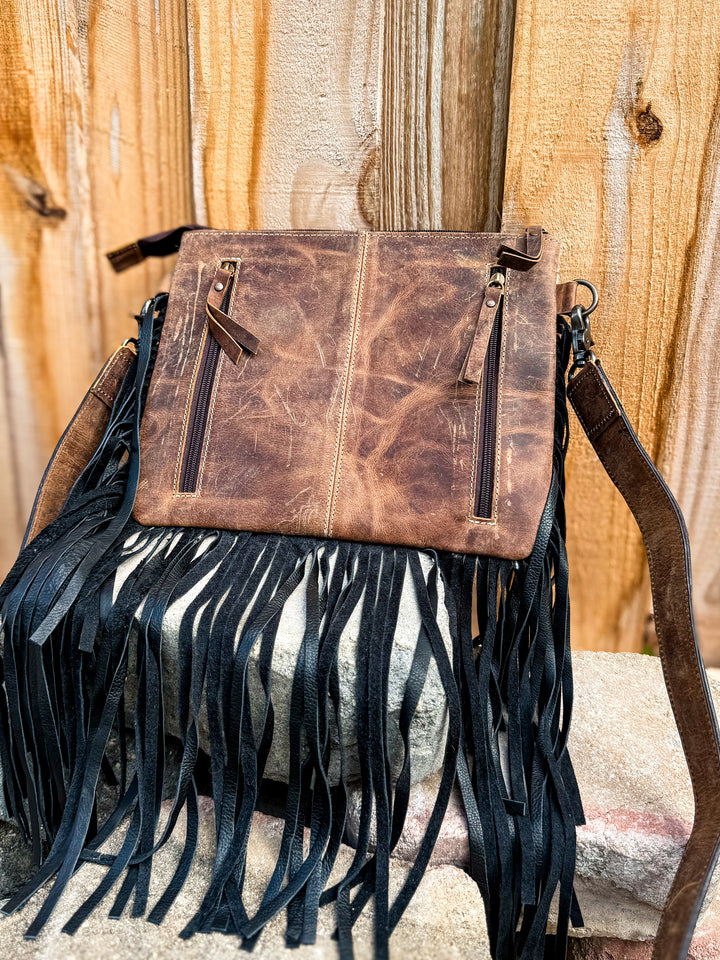 Back view of concealed carry purse with dual zipper compartments and black fringe