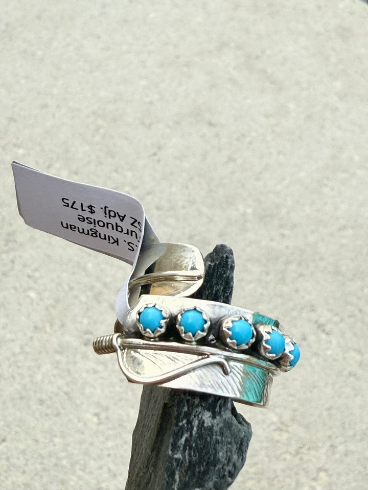 Side view of the Sterling silver bypass feather Kingman Turquoise ring handmade by Navajo artist Chester Charley