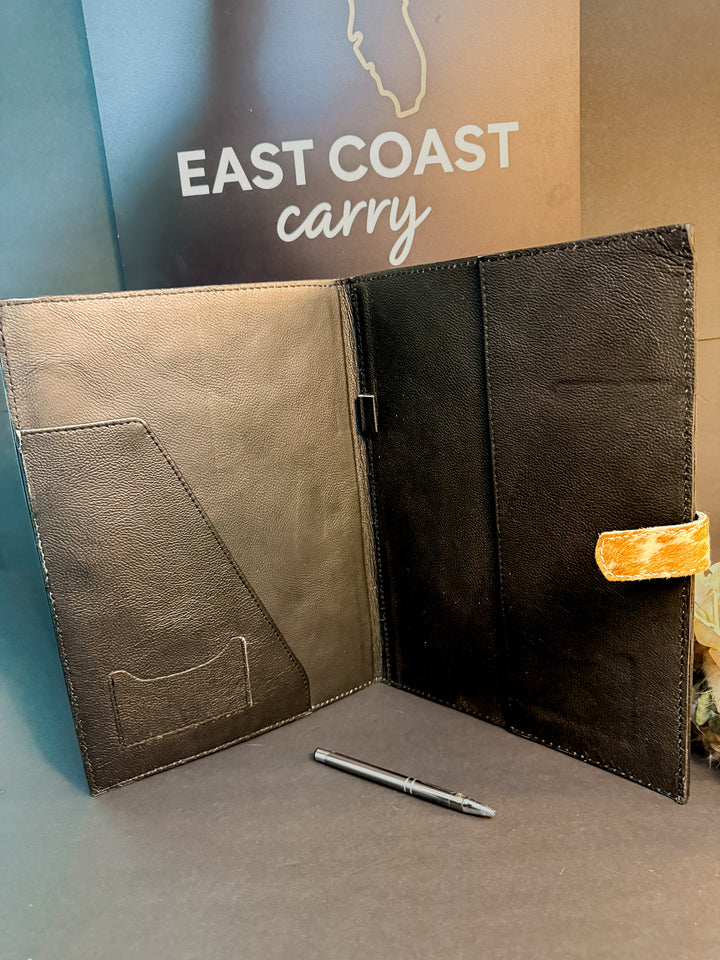 Interior of leather portfolio showing legal pad slot and notebook storage.