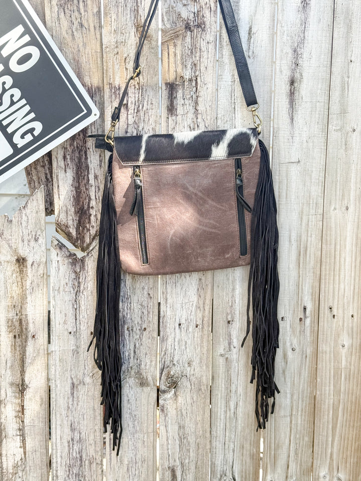 Women’s western concealed carry purse showing back double zipper access and suede fringe 