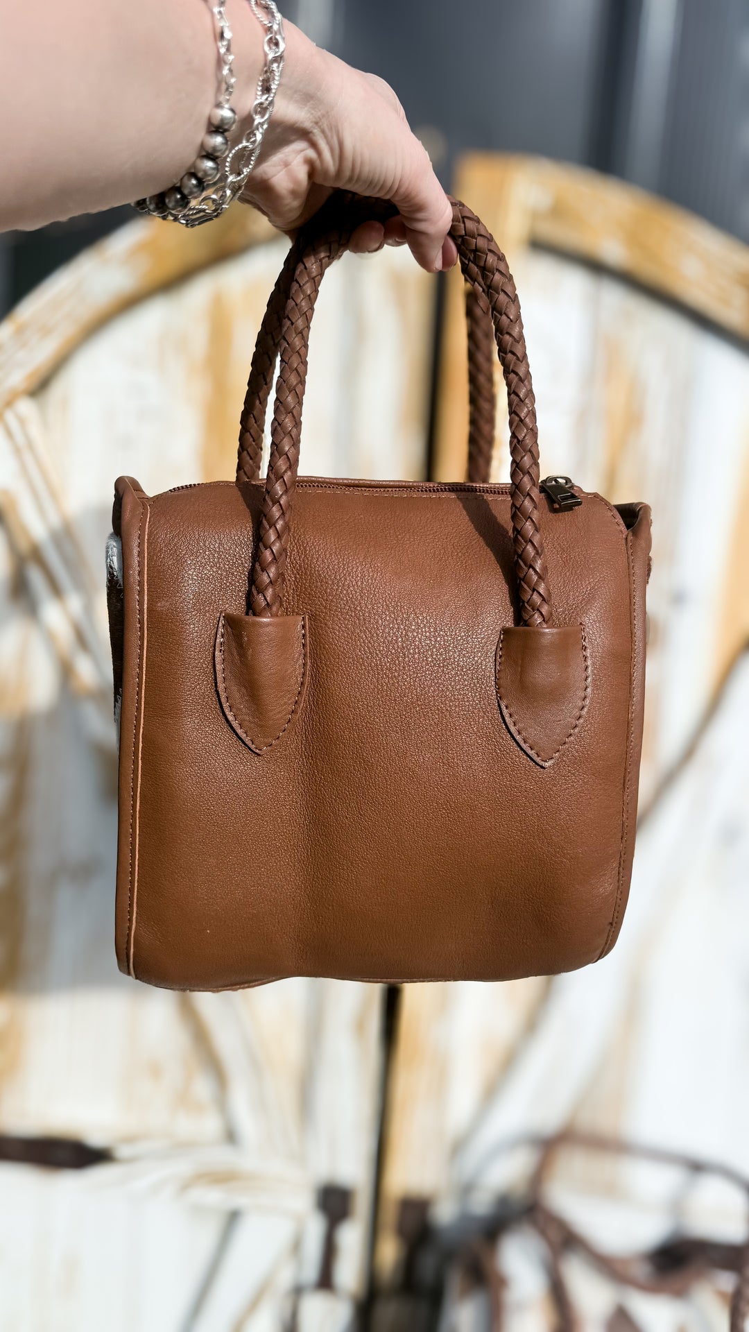 Back of Soft & Strong diamond patchwork satchel showing smooth brown leather, braided double handles and relaxed handbag shape.